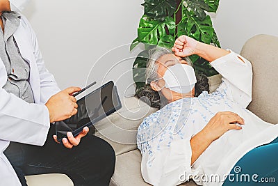 Male psychiatrist sits down and advises an elderly woman who sleeps in stress to relax during treatment for a mentally ill patient Stock Photo