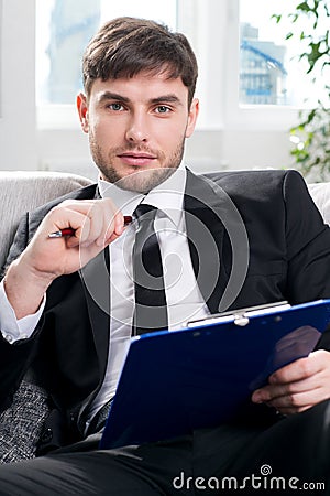 Male psychologist being ready to take notes Stock Photo