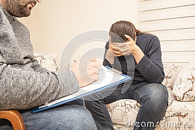 Male psychologist consulting sad depressive man at psychological therapy session, psychologist consultation and mental help Stock Photo