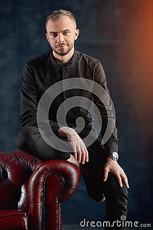 A male psychologist in his office is ready to receive patients, a concept of psychology, a beautiful stupid doctor, a Stock Photo