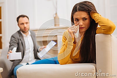 Male psychologist soothing his attractive patient Stock Photo