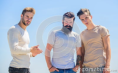 Male psychology. Young people bonding. Psychological help. People in depression. Men standing sky background. Group sad Stock Photo
