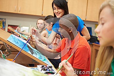 Male Pupil In High School Art Class With Teacher Stock Photo