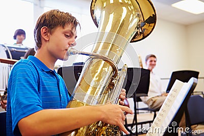 Male Pupil Playing Tuba In High School Orchestra Stock Photo
