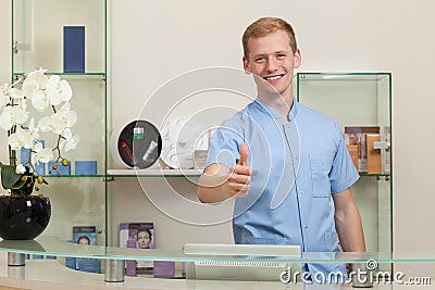 Male receptionist with okay gesture Stock Photo