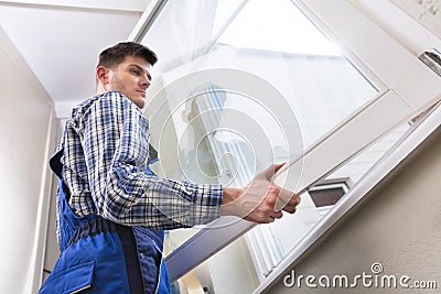 Male Repairman Installing Window Stock Photo