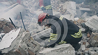 Male rescuers removing concrete rubble Stock Photo