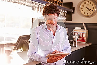 Male restaurant owner owner using digital tablet Stock Photo
