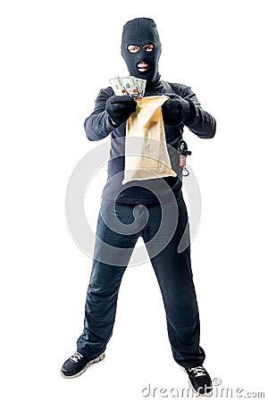 Male robber in full length is holding bag with money Stock Photo