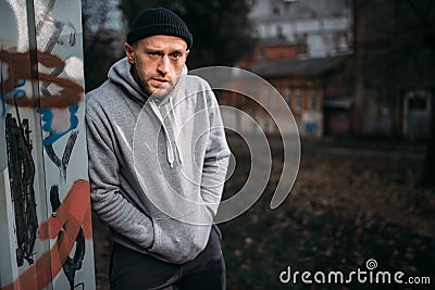 Male robber waiting for victim on the night street Stock Photo