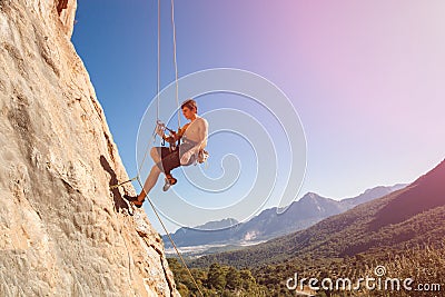 Male rock climber on belay rope Stock Photo