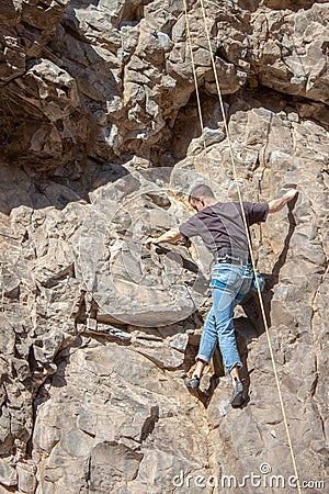 Rock climber in New Mexico attached to rock, climbing up canyon wall Editorial Stock Photo