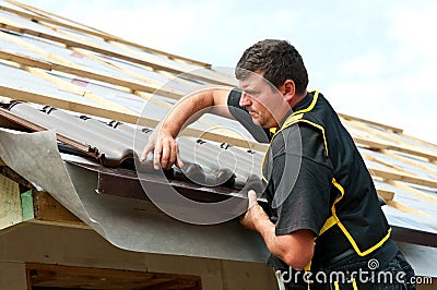 Male roofer fitting tiles Stock Photo