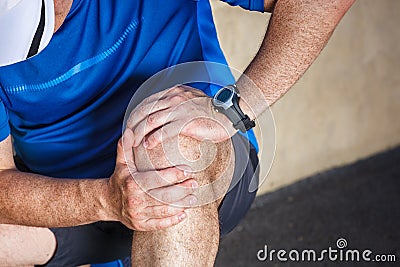 Male runner having problems in knee Stock Photo