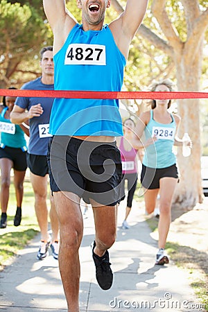 Male Runner Winning Marathon Stock Photo