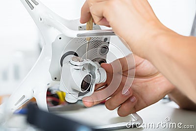 Male`s Hand Repairing Action Camera On Quadrocopter Drone Stock Photo