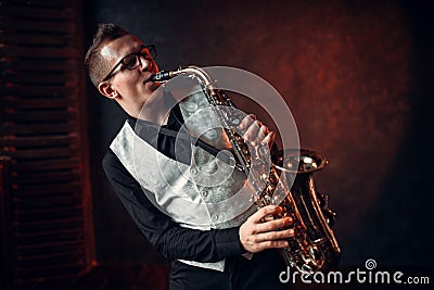 Male saxophonist playing classical jazz on sax Stock Photo