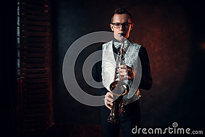 Male saxophonist playing jazz melody on saxophone Stock Photo
