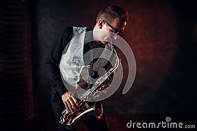 Male saxophonist playing jazz melody on saxophone Stock Photo