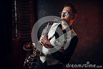 Male saxophonist playing jazz melody on saxophone Stock Photo