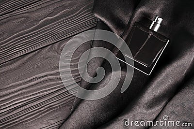 Male scent perfume bottle on dark silk background Stock Photo