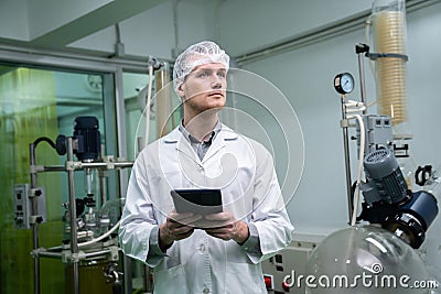 Scientist, apothecary working in laboratory for cannabis extraction with tablet. Stock Photo