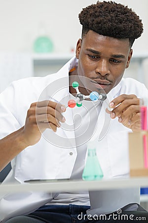 male scientist holding molecular model in lab Stock Photo