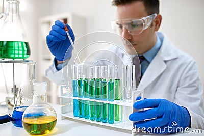 Male scientist using chemistry liquid for research Stock Photo