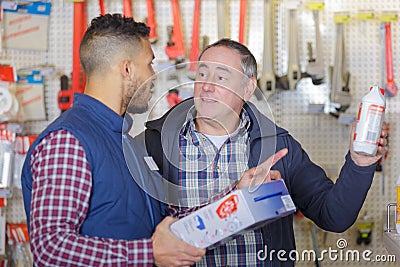 Male seller advising client in hardware store Stock Photo