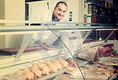 Male seller in halal section at supermarket Stock Photo