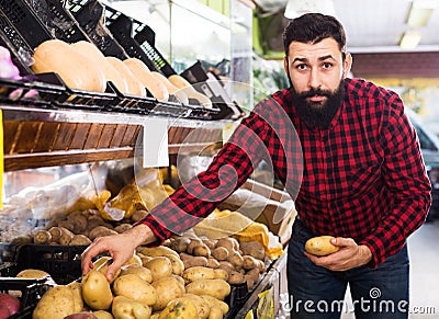 male seller moving fresh vegetables Stock Photo