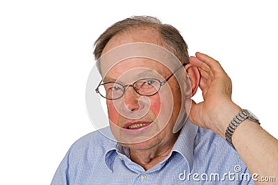 Male senior with hand on ear Stock Photo