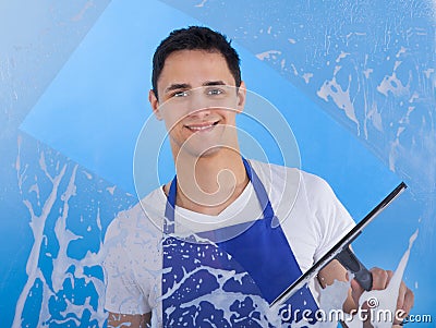 Male servant cleaning glass with squeegee Stock Photo
