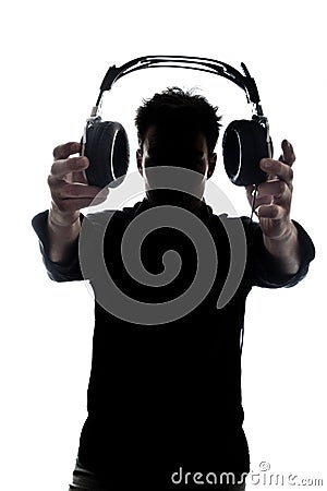 Male in silhouette showing headphones Stock Photo