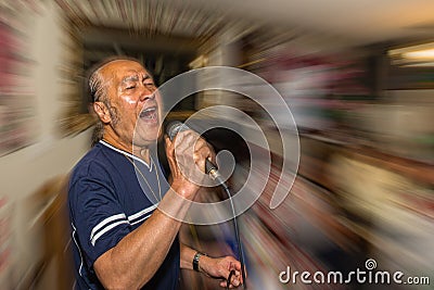 Male singer holding microphone Stock Photo