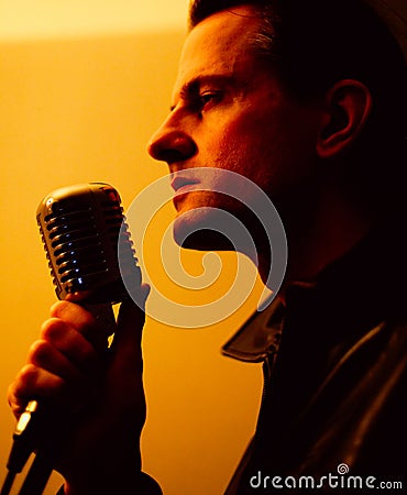 Male singer with microphone Stock Photo