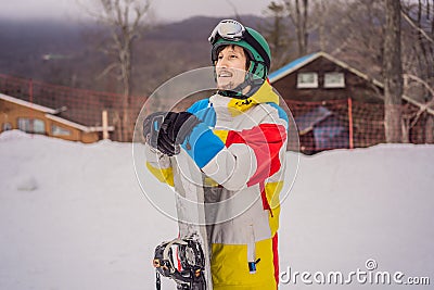 Male snowboarder at a ski resort in winter Stock Photo