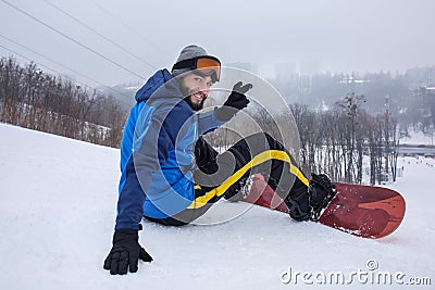 Male snowboarder on slope at winter resort Stock Photo