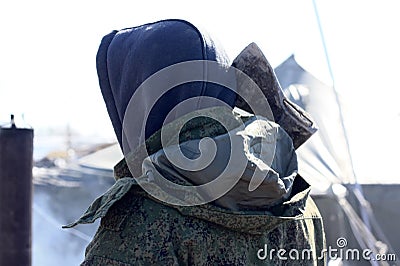 A male soldier holds an axe on his shoulder Stock Photo