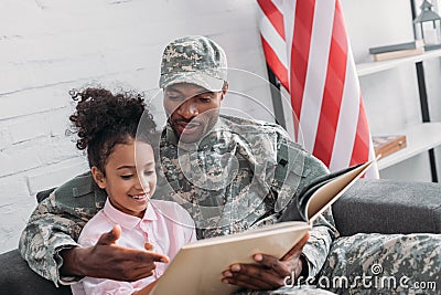 Male soldier reading book to Stock Photo