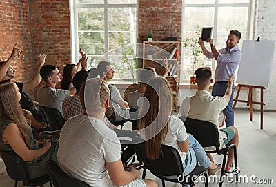 Male speaker giving presentation in hall at university workshop Stock Photo