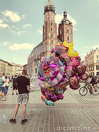 Male street vendor sells colorful popular cartoon character helium balloons Editorial Stock Photo