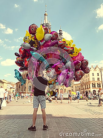 Male street vendor sells colorful popular cartoon character helium balloons Editorial Stock Photo