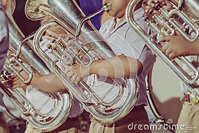 Male student with friends blow the euphonium with the band for performance on stage Editorial Stock Photo