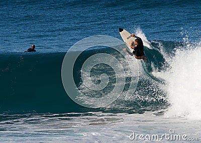 A male surfer smashing a frontside top-turn off-the-lip at Iluka`s North Wall. Editorial Stock Photo