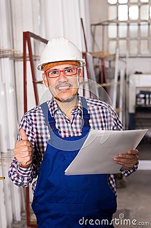 Male surveyor in coverall doing checkup and filling papers Stock Photo