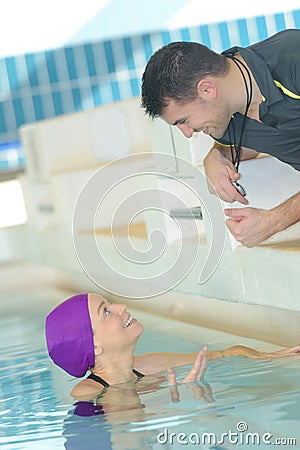 male swimming coach with female swimer Stock Photo