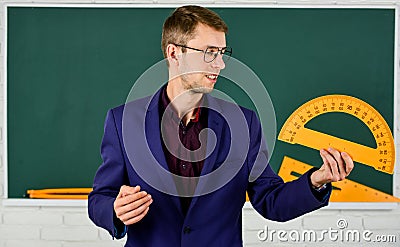 Male teacher hold protractor. education and school concept. stem school disciplines. mathematics and people concept. man Stock Photo