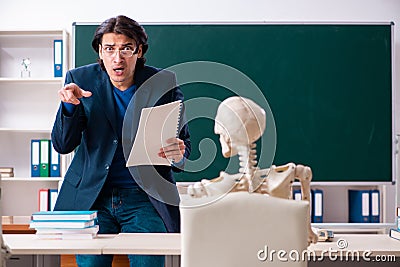 Male teacher and skeleton student in the classroom Stock Photo
