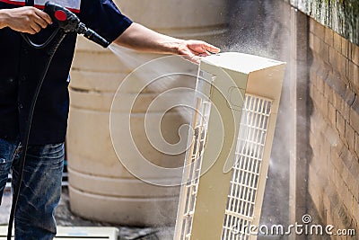 Male technician cleaning air conditioner indoors, Repairman washing dirty compartments air conditioner, Maintenance and repairing Stock Photo